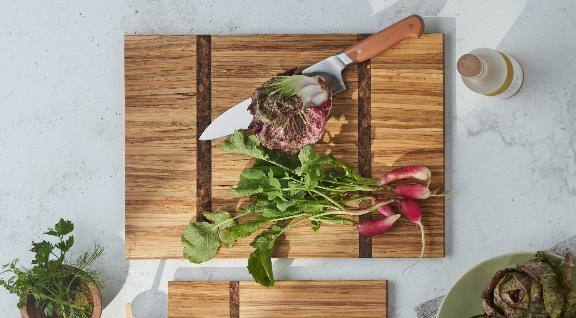 two cutting board with a bunch of red radishes on top of one of the boards