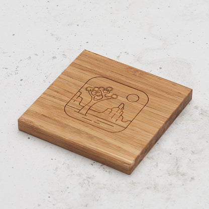 An overhead view of one of the all day every day coasters with an engraved image of Joshua Trees in the middle