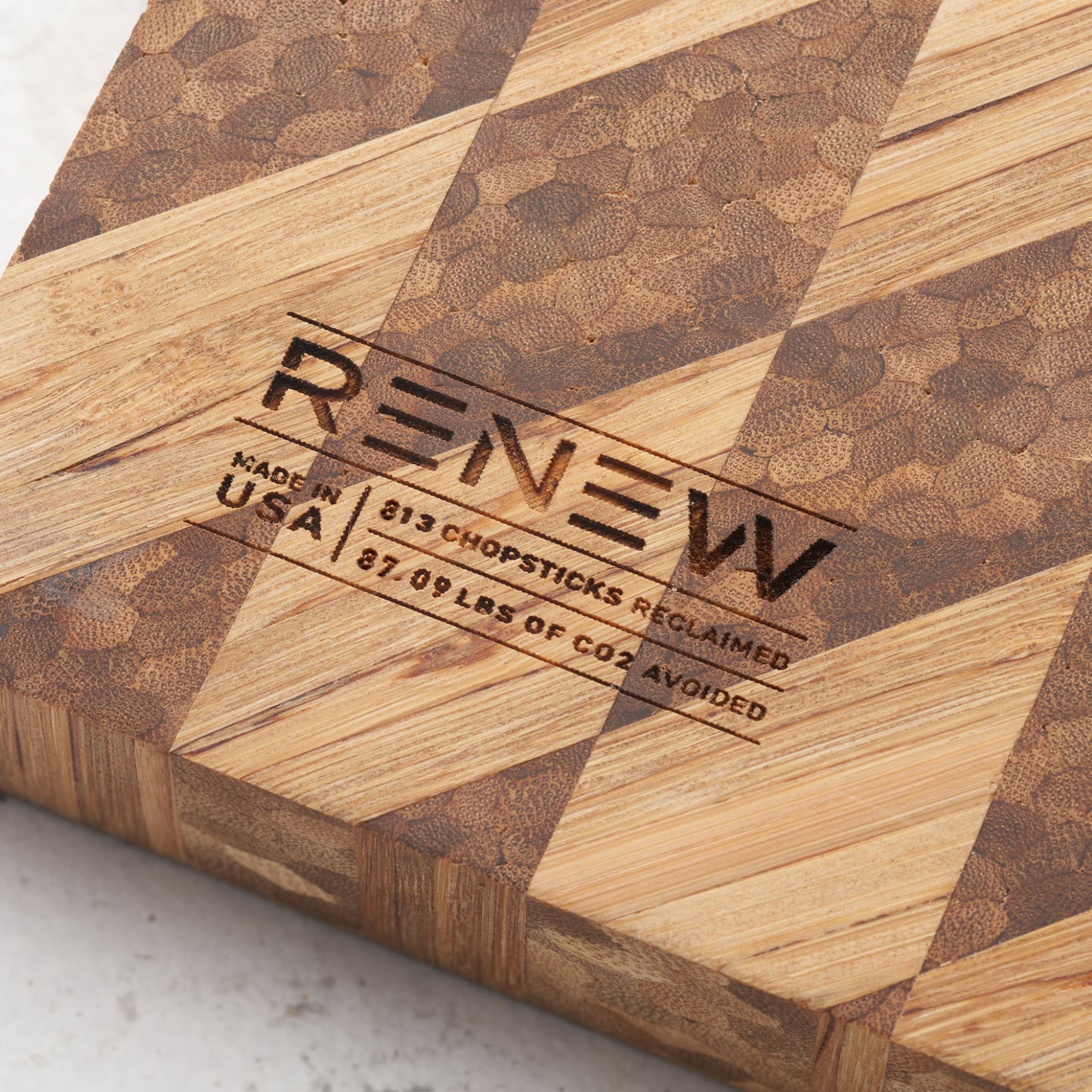 impact metrics on the back of board saying 813 chopsticks reclaimed, 87.09 lbs of co2 avoided